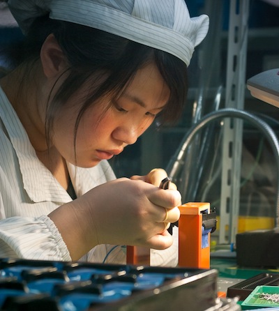 Chinese worker assembles a camera