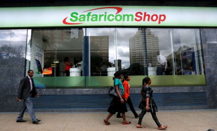 This is phot shows Pedestrians walk past a mobile phone care centre operated by Kenyan's telecom operator Safaricom in the central business district of Kenya's capital Nairobi, May 11, 2016.
