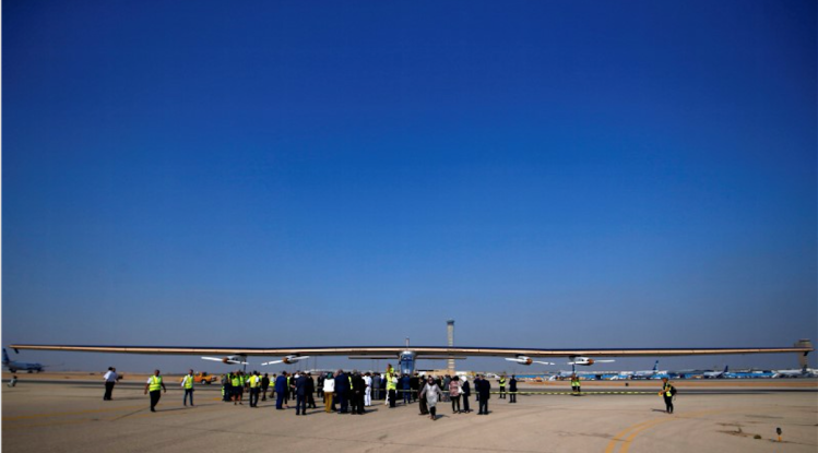 This is a photo of Solar Impulse 2, a solar powered plane, is surrounded by journalists and media after its landing at Cairo Airport, Egypt July 13, 2016.