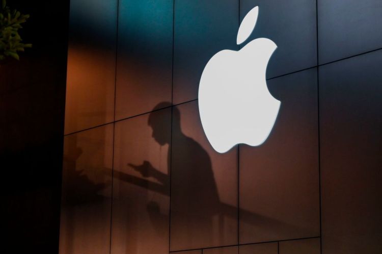 The shadow of a man is cast on the wall of an Apple store as he uses his mobile phone in Beijing on August 26, 2019. - There were signs of a thaw in frosty trade-war tensions between China and the US on August 26 as President Donald Trump said delegations would "very shortly" resume talks and Beijing's top negotiator called for "calm". (Photo by GREG BAKER / AFP)        (Photo credit should read GREG BAKER/AFP/Getty Images)