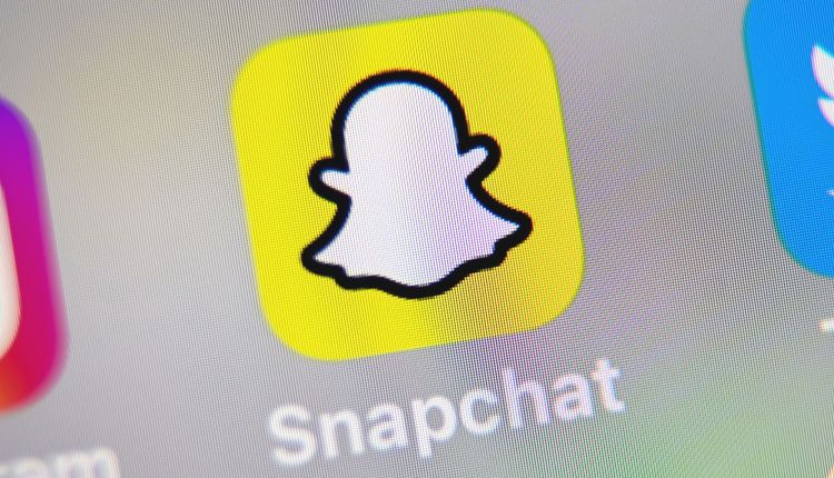 A picture taken on October 1, 2019 in Lille shows the logo of mobile app Snapchat displayed on a tablet.