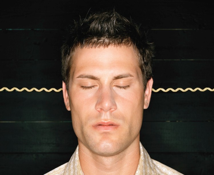 Man with eyes closed, listening