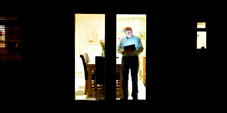 An elderly person using a tablet
